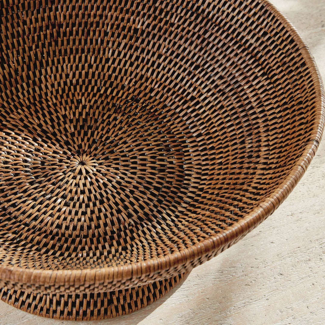 Close-up of warm brown rattan pedestal offering bowl showing its tightly woven interior and rounded base detail, Transitional