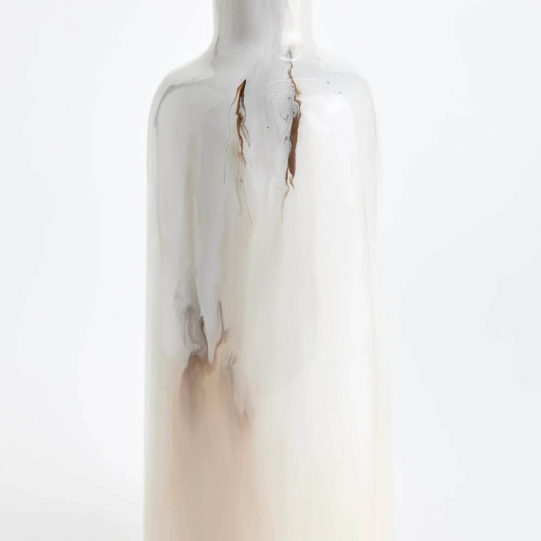 This decorative vase, made of enameled iron, showcases a clever design of hand-painted layers in a creamy mocha color inspired by a latte. Crafted with a unique method and artistic expertise, this vase embodies the essence of a delicious coffee drink, making it a sophisticated addition to any home decor.