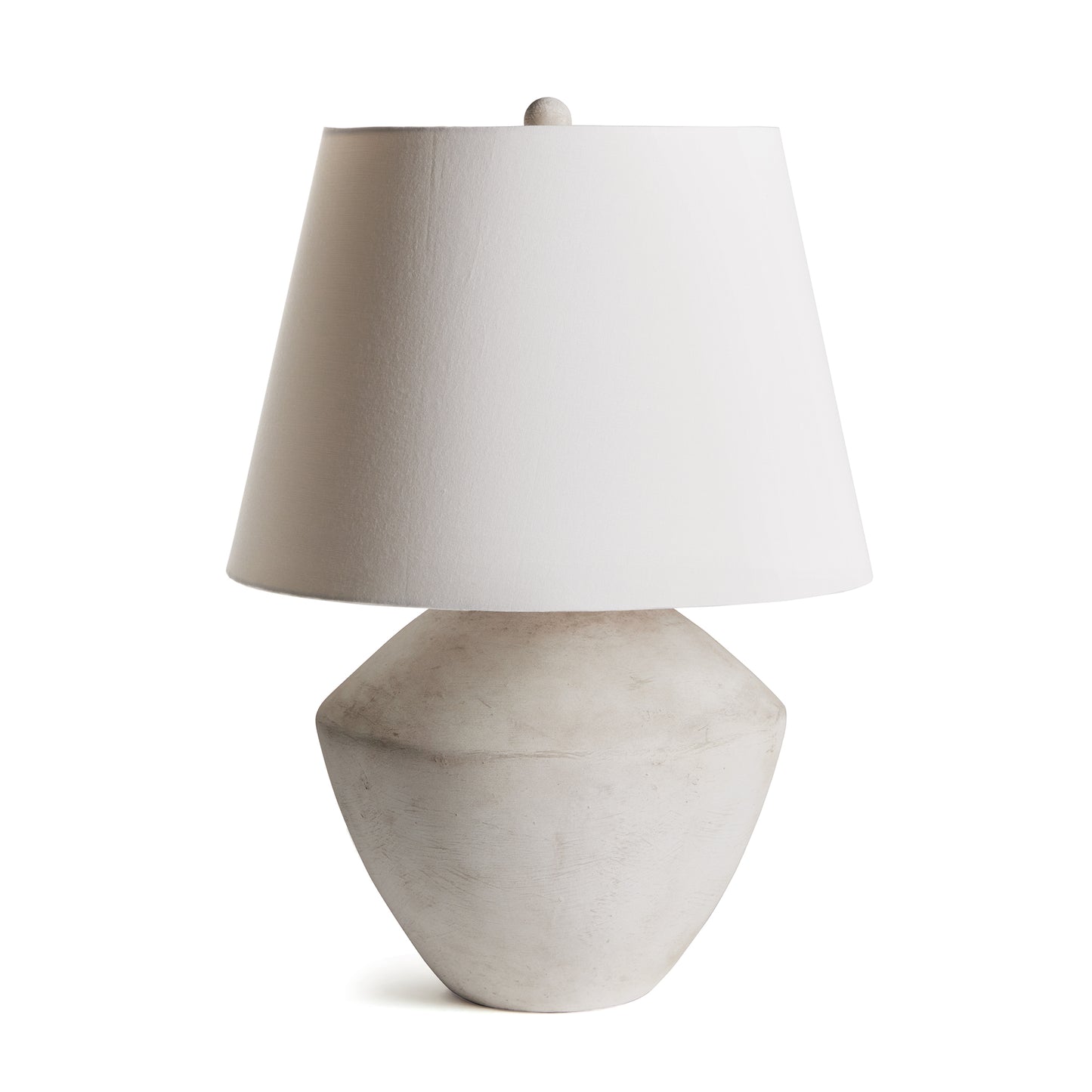 This handsome lamp has a classic silhouette. The body was crated from a centuries old wooden mold. We brought it back to life in this warm stone finish. Topped with a tapered fabric shade, it makes a dynamic, storied lamp for family room, study or bedroom.