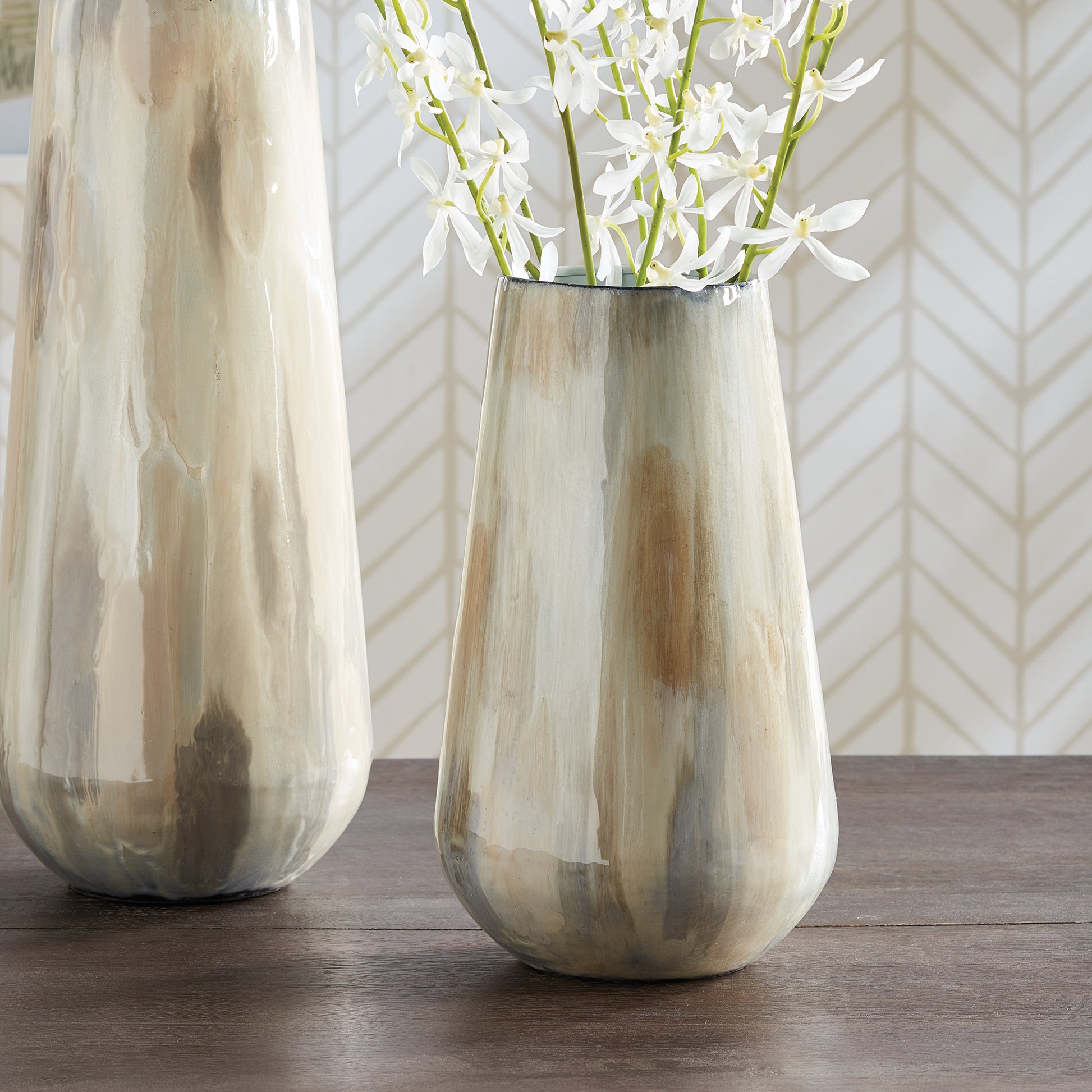 Using enameled iron in an innovative manner, these delicately crafted vases are hand-painted, each one featuring a charming tone-on-tone design. This technique produces a lovely light and creamy effect, making for a distinctive addition to any space. Crafted with expertise, Almeta White Pearl Vase Small stands out with its innovatively crafted enameled iron and charming tone-on-tone design. This unique technique produces an elegant, light and creamy effect that adds a distinctive touch to any room.