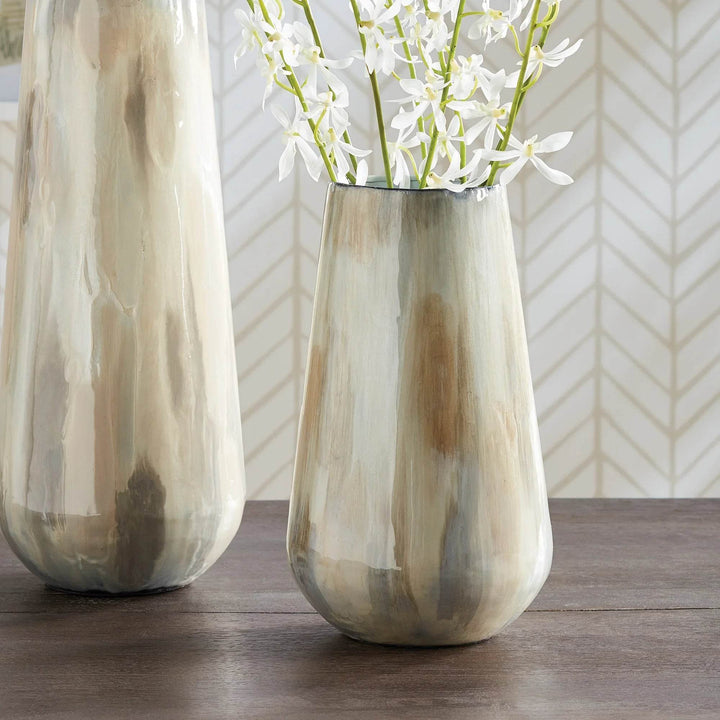 Using enameled iron in an innovative manner, these delicately crafted vases are hand-painted, each one featuring a charming tone-on-tone design. This technique produces a lovely light and creamy effect, making for a distinctive addition to any space. Crafted with expertise, Almeta White Pearl Vase Small stands out with its innovatively crafted enameled iron and charming tone-on-tone design. This unique technique produces an elegant, light and creamy effect that adds a distinctive touch to any room.