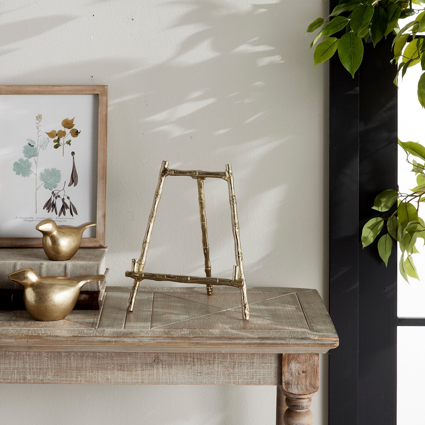 Constructed to hold platters, cookbooks, or a small work of art, this easel is both durable and sturdy. Its elegant gold bamboo accents offer a touch of classic charm, while providing versatility for showcasing your treasured items. With a seamless blend of traditional aesthetics and modern practicality, this easel is a formidable choice.