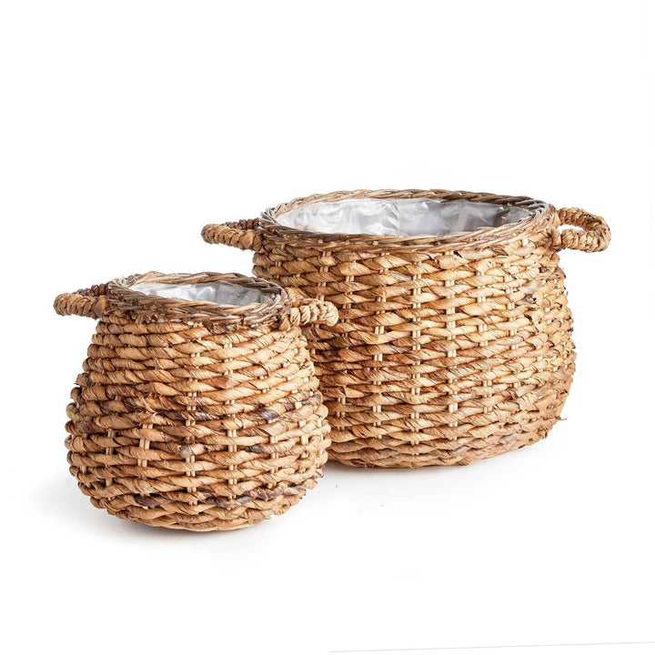 Two abaca basket planters shown together with plastic liners, natural woven fiber texture and size variation for indoor use - Modern Organic.