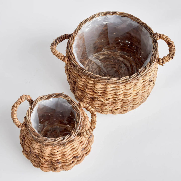 Set of two abaca basket planters with plastic liners, rounded woven construction and side handles for indoor plants - Modern Organic.