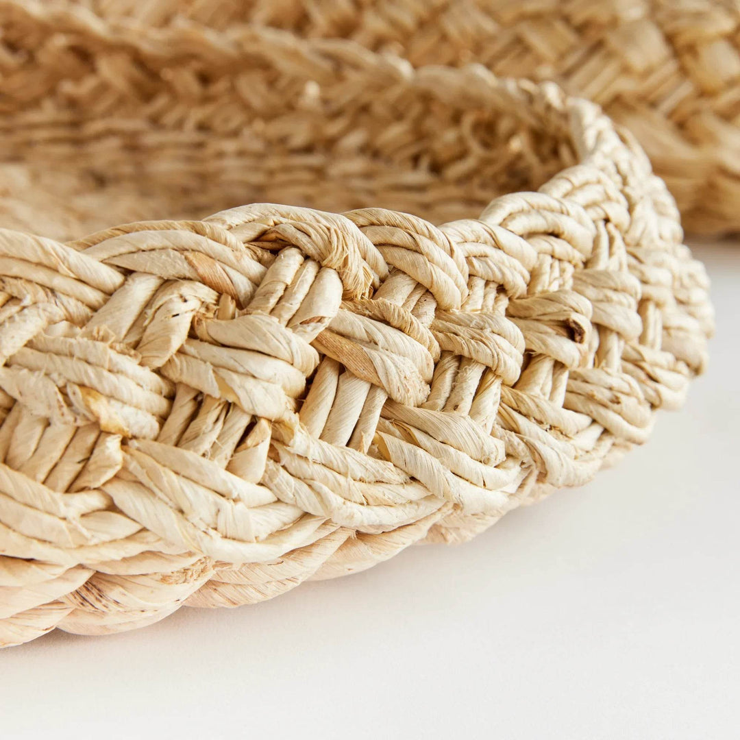 Closeup of French braid rim on handwoven abaca tray, showing thick plaited weave and artisanal detail – Coastal.