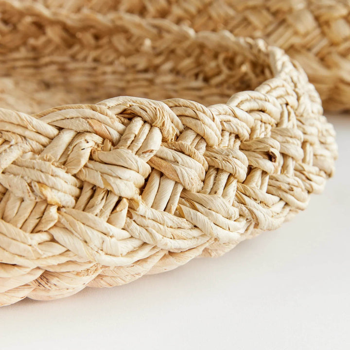Closeup of French braid rim on handwoven abaca tray, showing thick plaited weave and artisanal detail – Coastal.