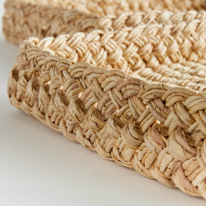 Close-up of braided edge detail on natural abaca rectangular tray, artisan basket craftsmanship