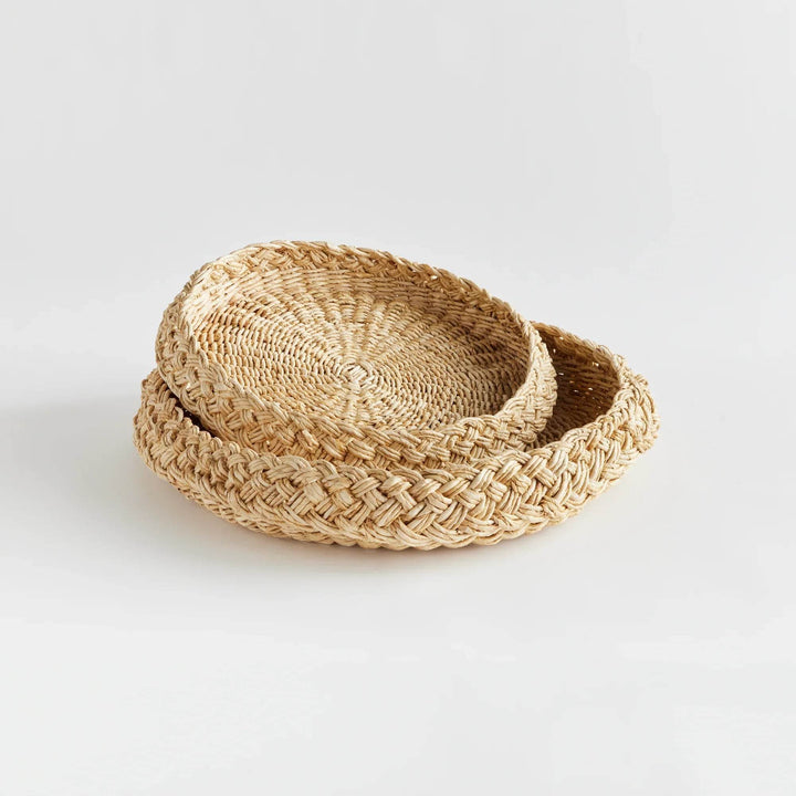 Side view of round abaca display trays, nested set of two showing low rim and tray profile in natural fiber – Coastal.