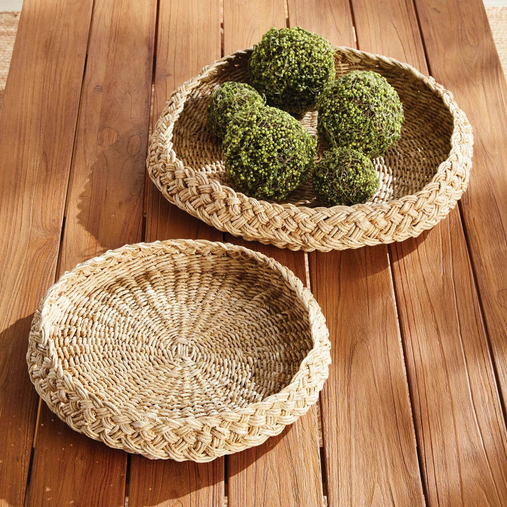 Round abaca display trays set of two styled on wood table with green decor accents, natural woven texture – Coastal.