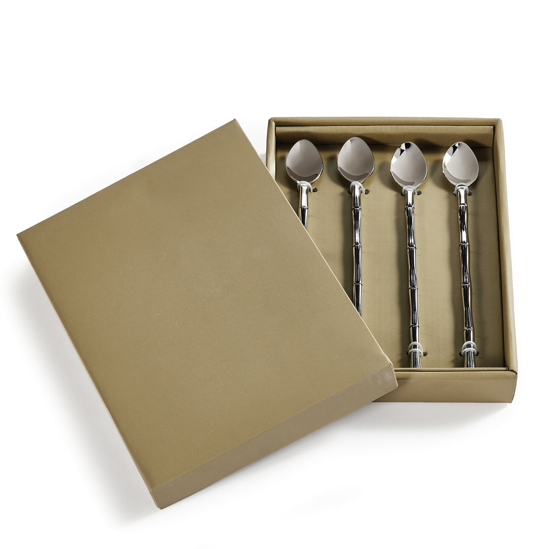 Four stainless steel stirring spoons with segmented handles arranged in an open gift box on a white backdrop - Transitional
