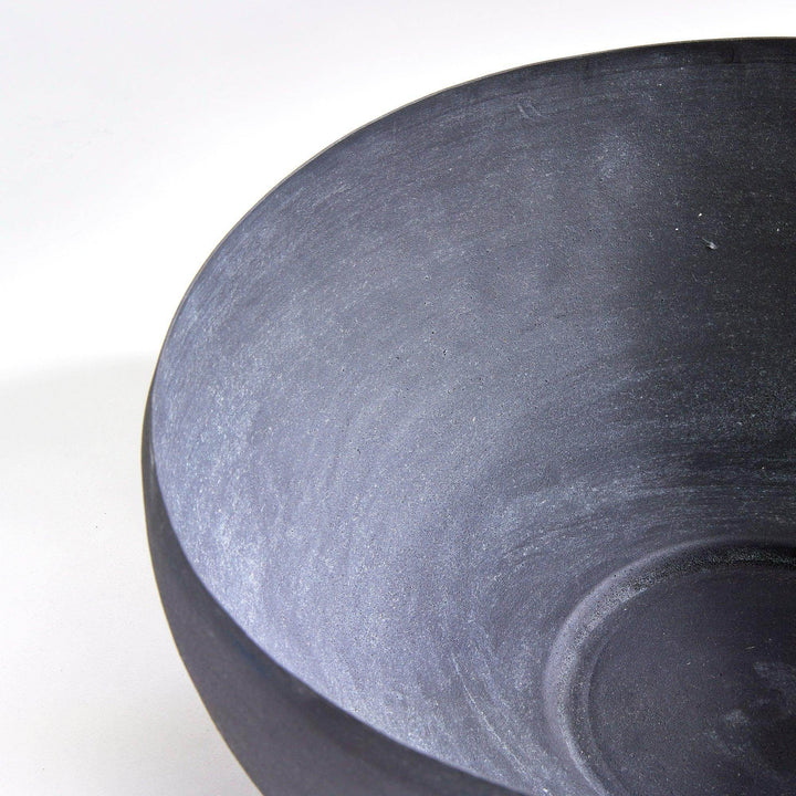 Close-up of decorative metal bowl rim with layered aged zinc finish and sculptural curved silhouette – European Garden style.