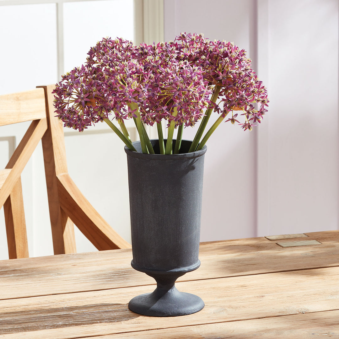 Decorative metal urn vase with pink faux florals and aged zinc finish in European garden style