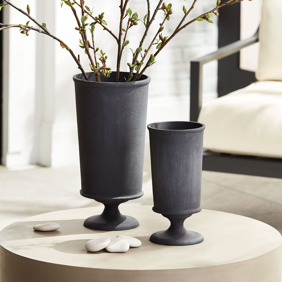 Pair of decorative metal urn vases with faux stems in aged zinc finish and European garden style