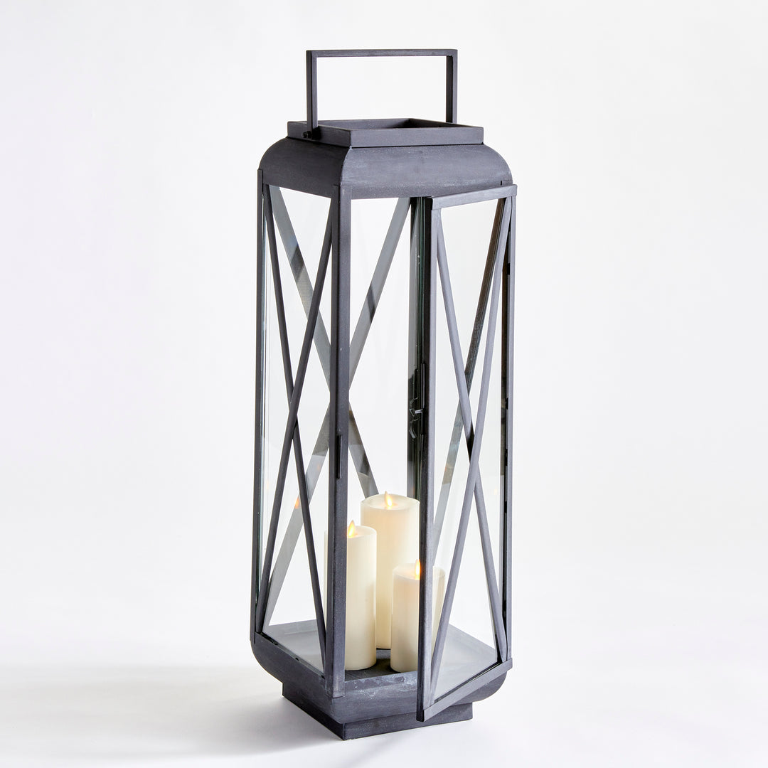 Medium outdoor metal lantern with glass panels and aged zinc finish styled for floor-scale outdoor decor – Modern Farmhouse style.
