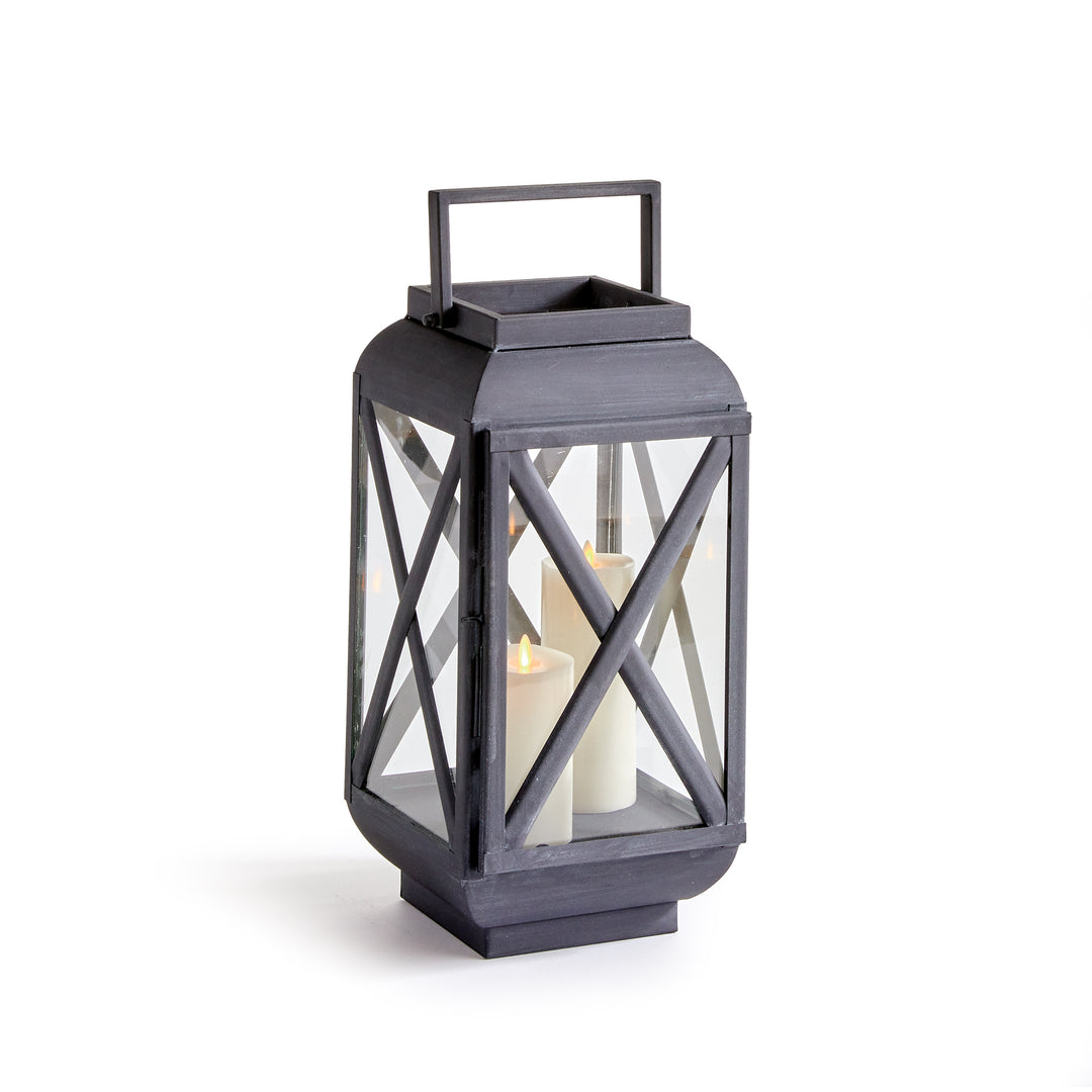 Small outdoor metal lantern with glass panels and aged zinc finish for patios, porches, and candlelit outdoor styling – Transitional style.