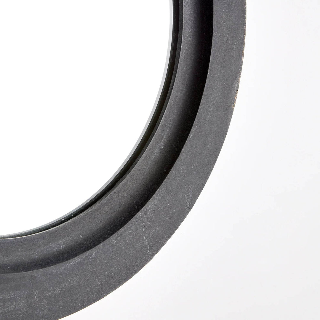 Close-up of round metal wall mirror frame with aged zinc finish and softly weathered texture – Industrial style.
