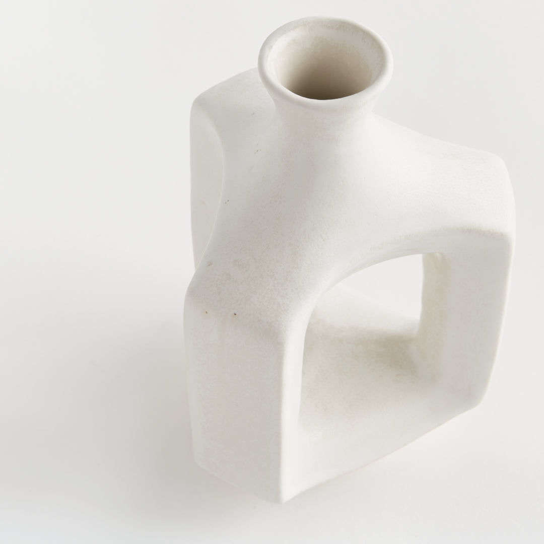 Short matte white clay vase, close view of the circular mouth, narrow neck and rounded matte white shoulder. Modern Organic