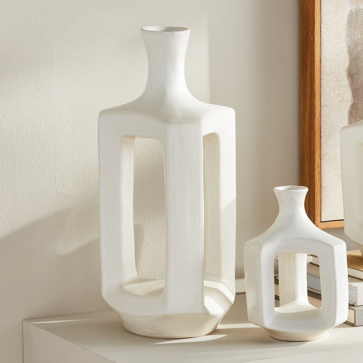Tall matte white clay vase, styled beside coordinating white vases, with an open frame and a narrow neck. Modern Organic