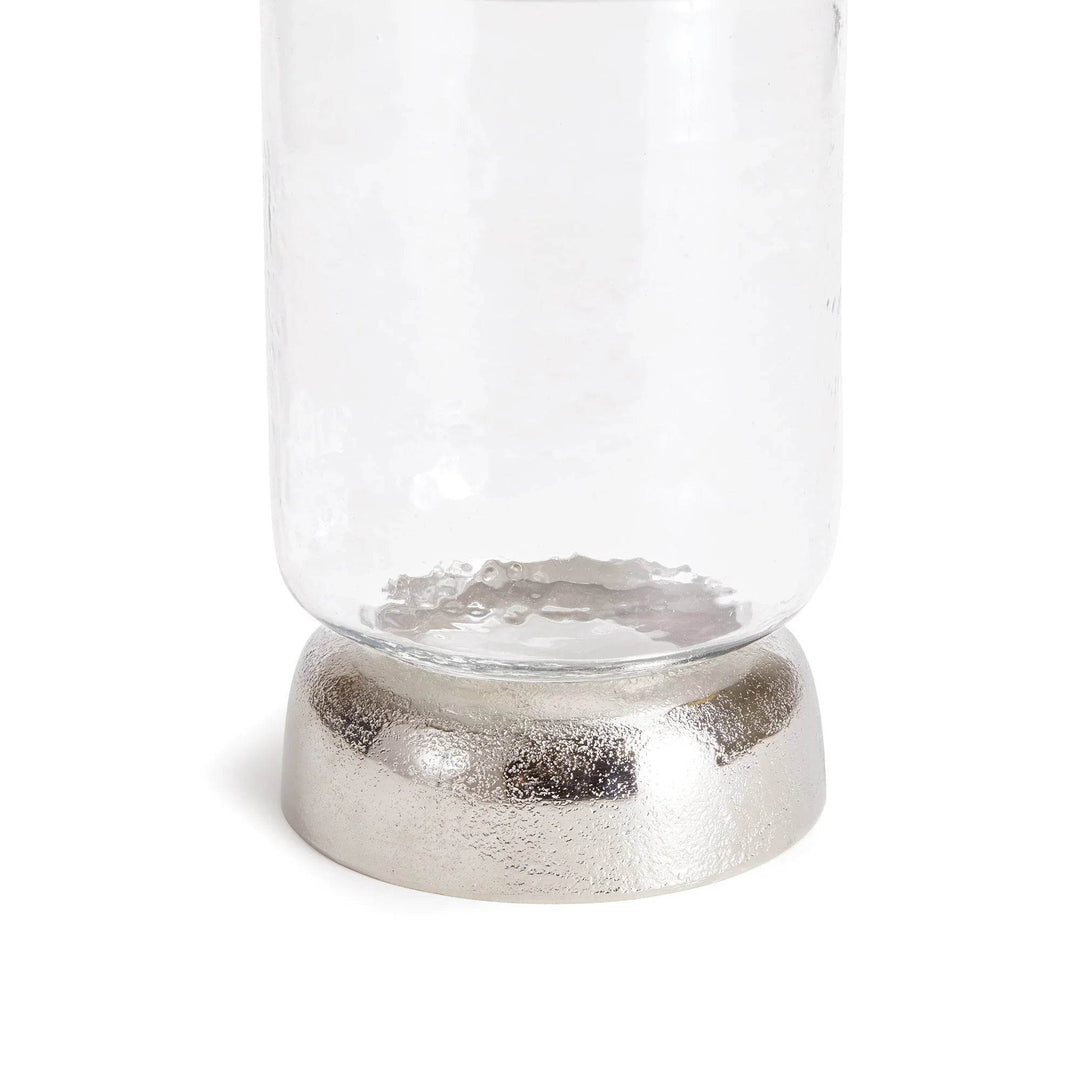 Angled view of small hurricane candle holder with sculptural base and clear textured glass – Transitional Modern


