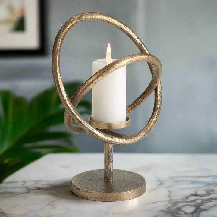 Angled view of modern gold candle holder with dimensional ring structure and round base – Sculptural Modern

