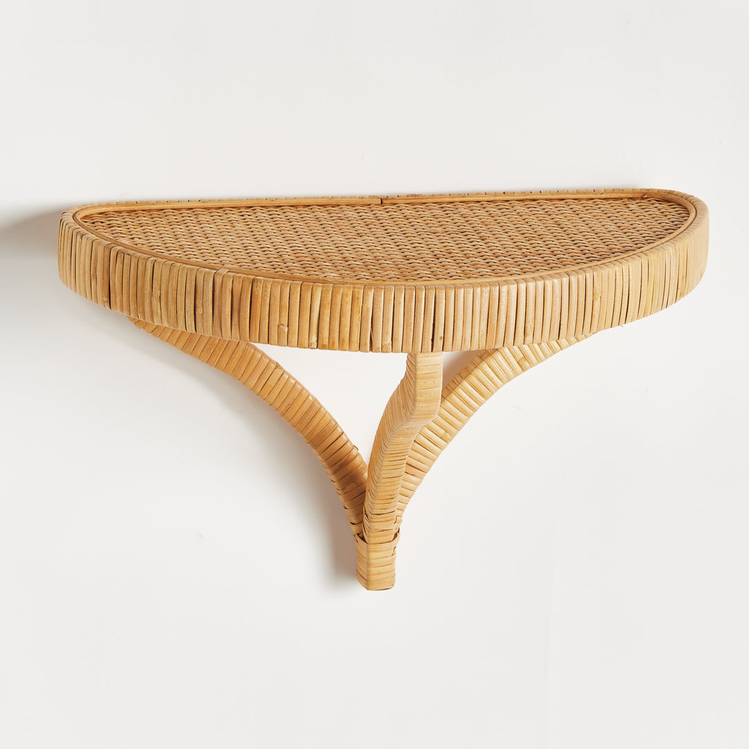 Angled perspective of large natural rattan wall bracket shelf with sculptural support – Organic utility style
