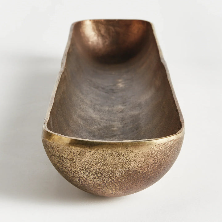 Close-up of antique brass cast aluminum decorative bowl showing textured finish and raised foot detail for elevated styling modern organic