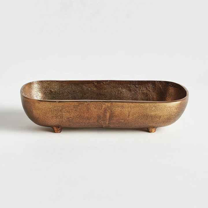 Close-up of small antique brass cast aluminum decorative bowl showing textured finish and raised foot detail modern organic