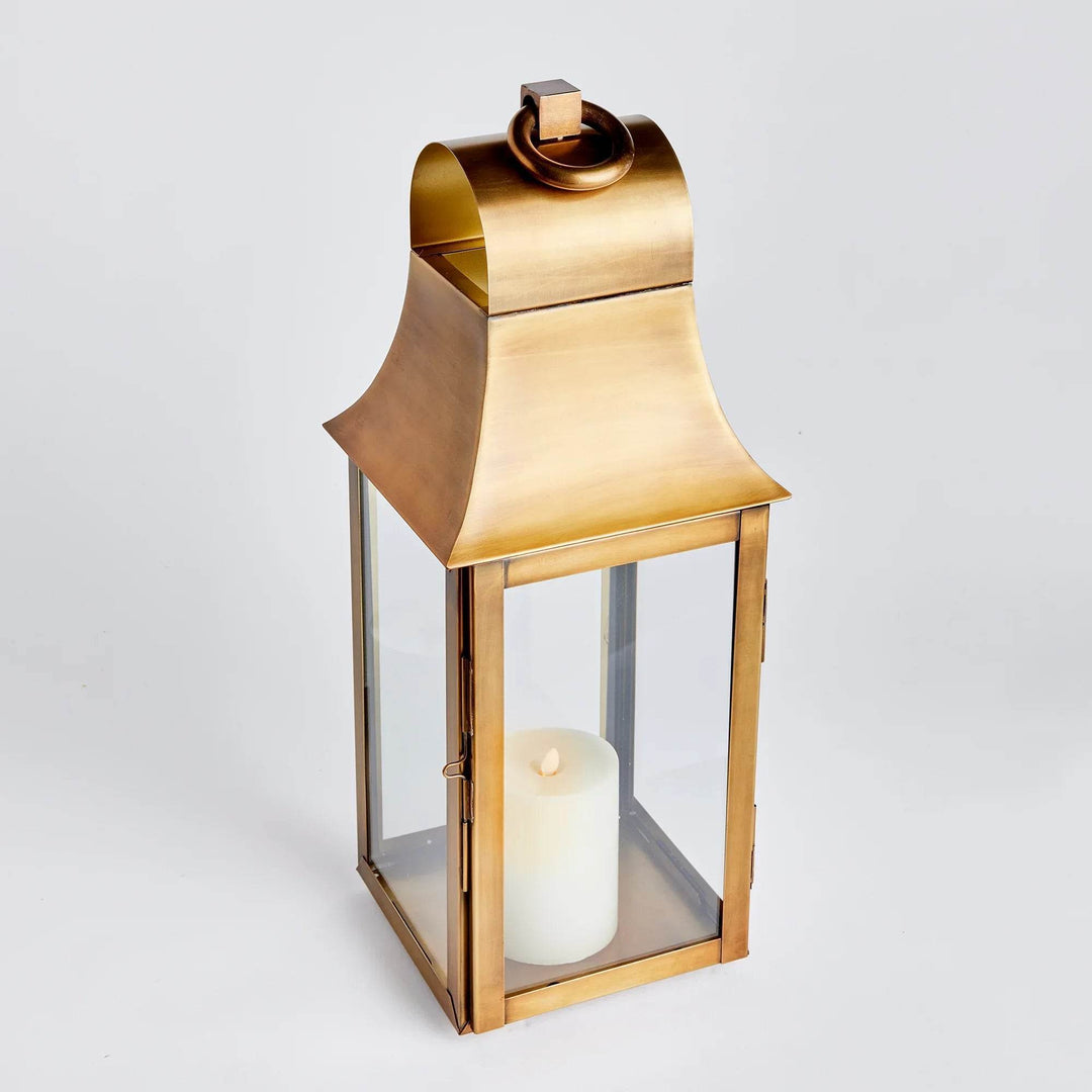 Small 21.5 inch lantern in antique brass with clear glass panels and LED candle inside, shown on white background – Transitional Classic Lantern