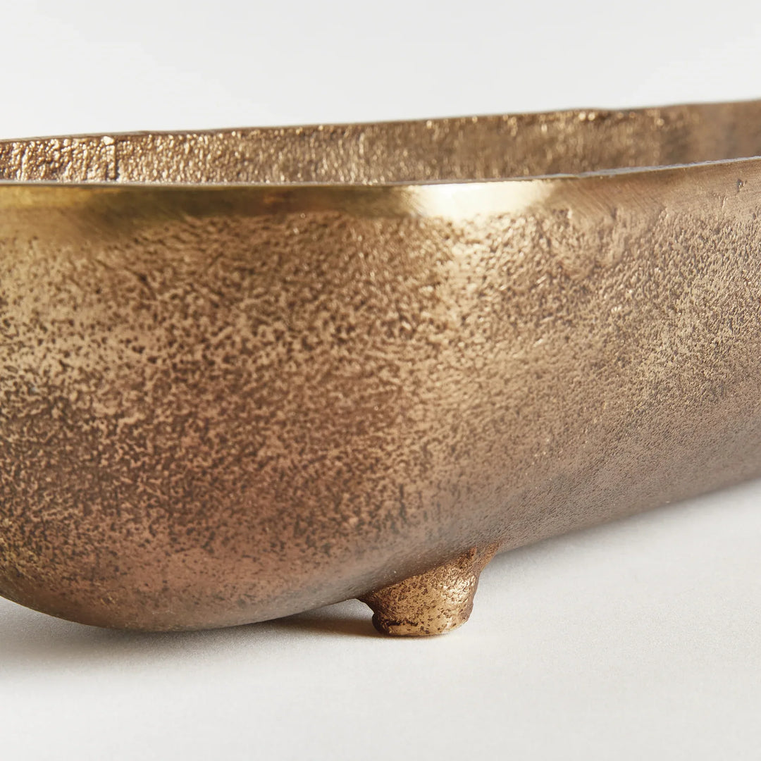 Antique brass narrow decorative bowl end view highlighting curved depth sculpted shape and warm metallic finish modern organic
