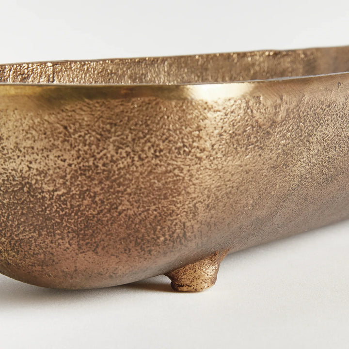 Antique brass narrow decorative bowl end view highlighting curved depth sculpted shape and warm metallic finish modern organic