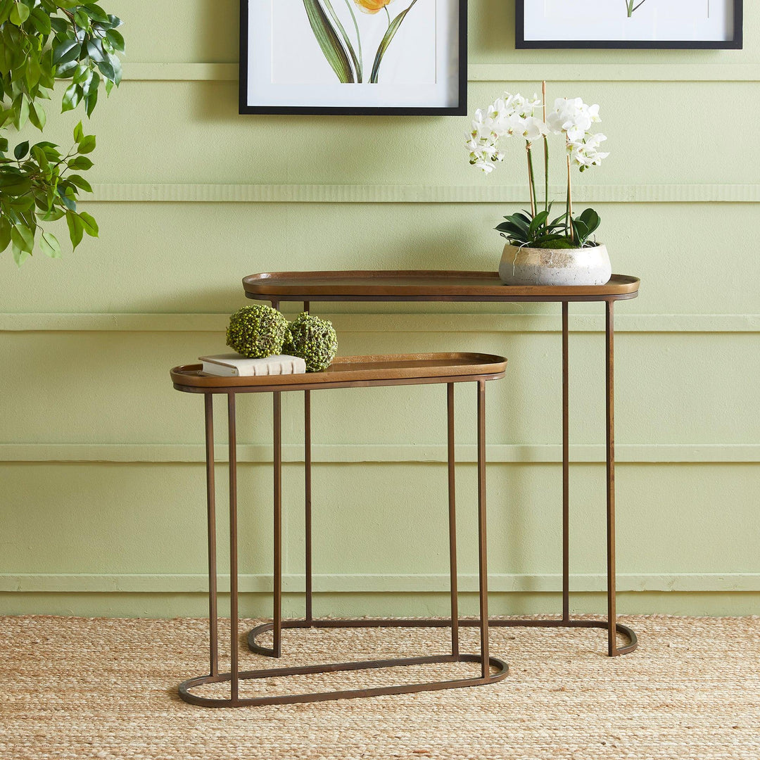 Antique brass metal nesting console tables styled in living room with decor accents and layered modern transitional design
