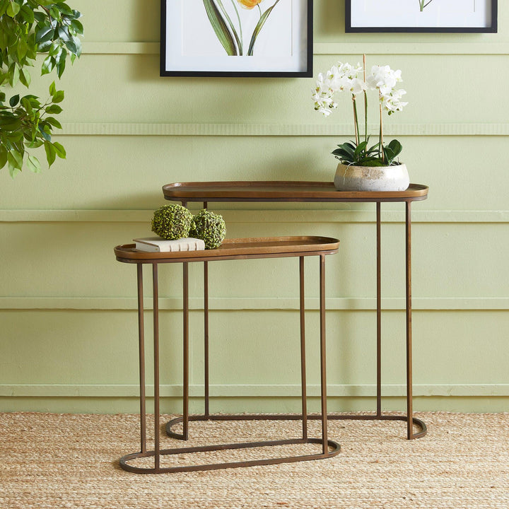 Antique brass metal nesting console tables styled in living room with decor accents and layered modern transitional design