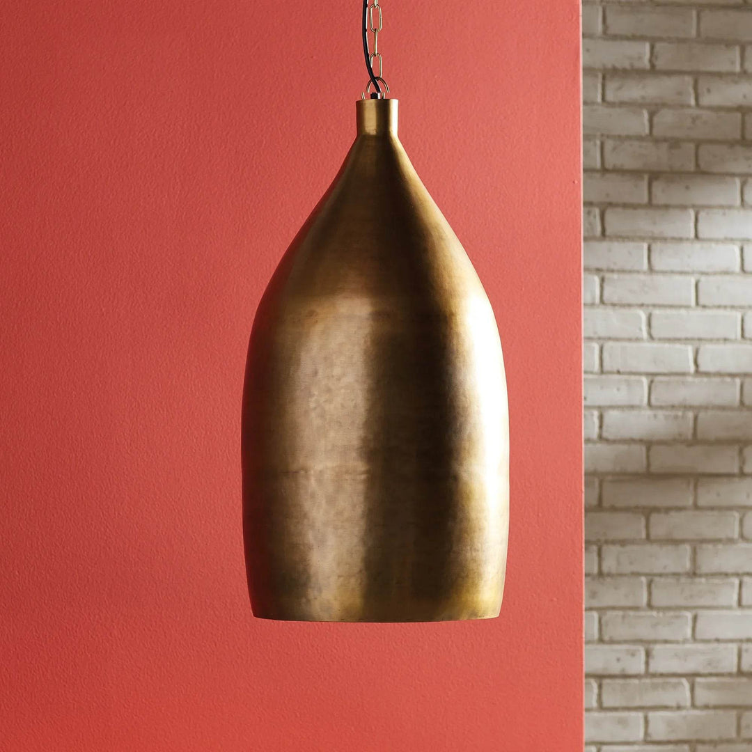 Large antique brass pendant light with chain suspension, shown against red accent wall and white brick background – Modern Industrial