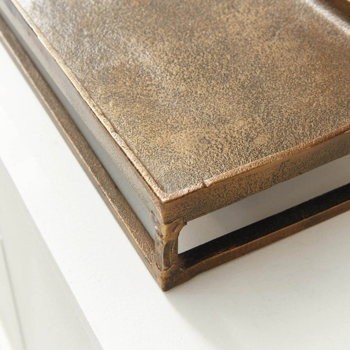 Corner detail of raised antique brass rectangular tray highlighting rim and elevated base – Modern Industrial