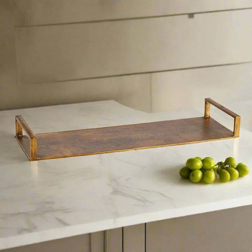 Antique brass rectangular tray styled on a light kitchen counter with green decorative accents – Modern Industrial
