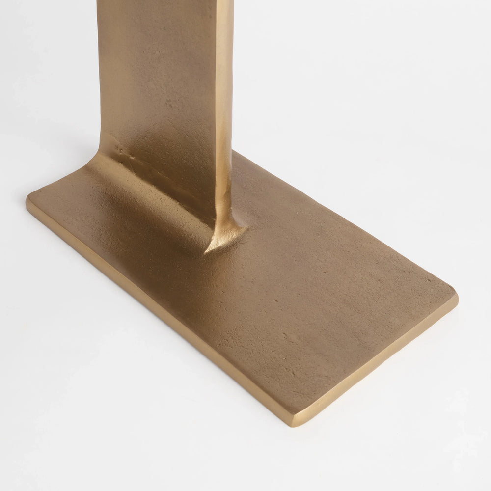 Close detail of narrow antique brass side table showing aluminum pedestal base and textured metallic finish, Contemporary Minimalist