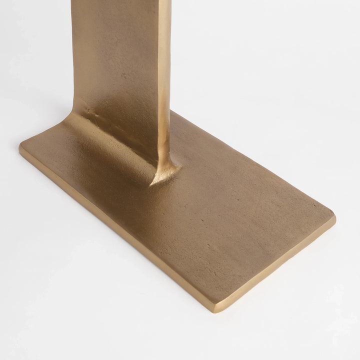 Close detail of narrow antique brass side table showing aluminum pedestal base and textured metallic finish, Contemporary Minimalist