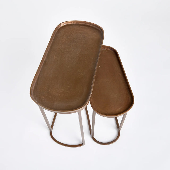 Antique brass nesting end tables with tray tops, overhead view showing rounded shape and warm metallic finish – Modern