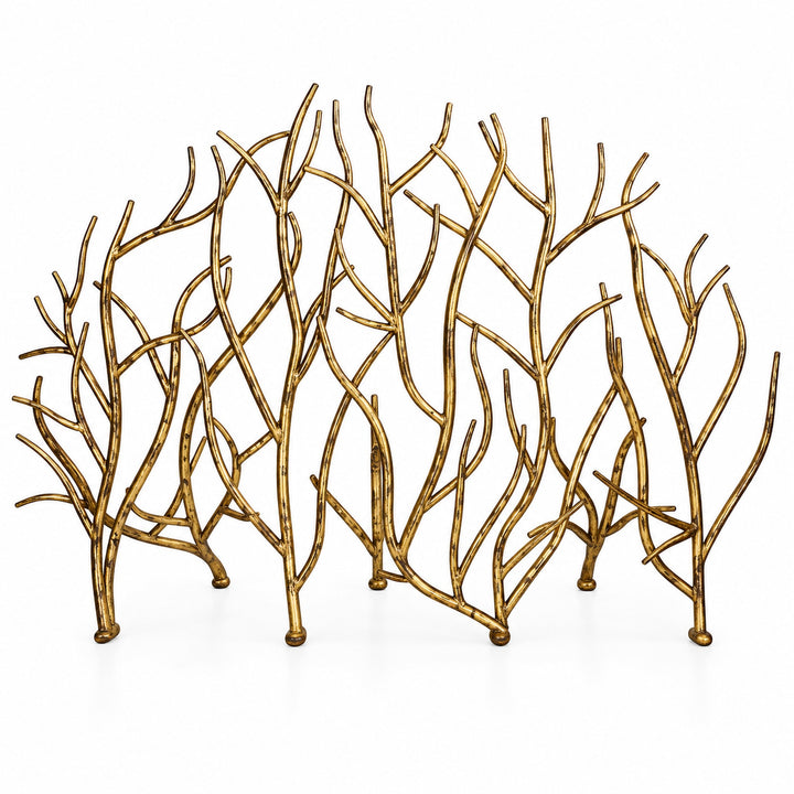 A decorative gold metal branch fireplace screen with an organic, coral-like silhouette, photographed against a seamless white background.