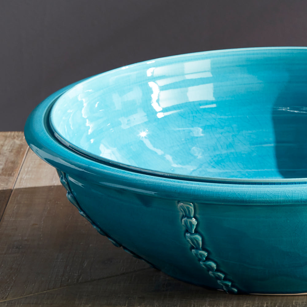 Top view of aqua ceramic bowl showing glossy glaze and shell detailing, handmade in Italy – Coastal Mediterranean

