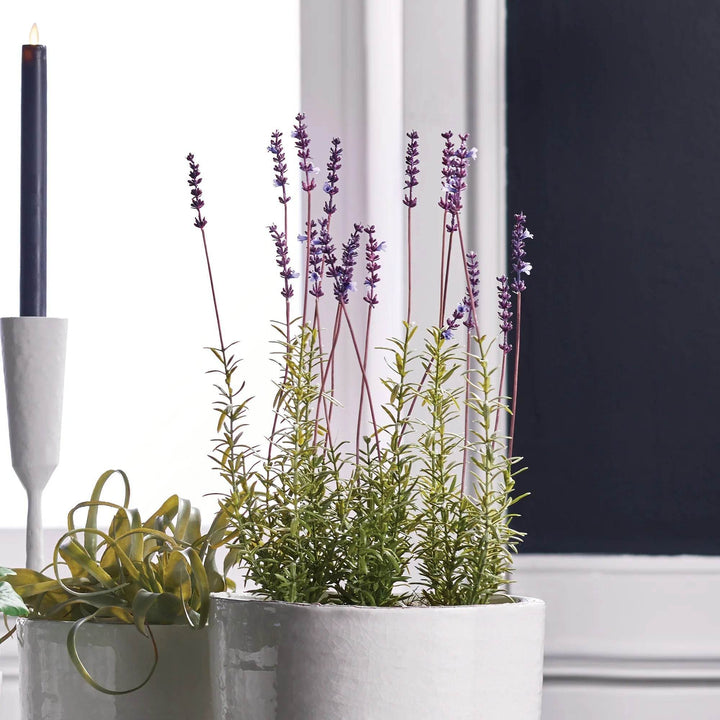 Artificial potted French lavender plant styled indoors on windowsill with candle and decor, realistic purple blooms for home styling – French Country.

