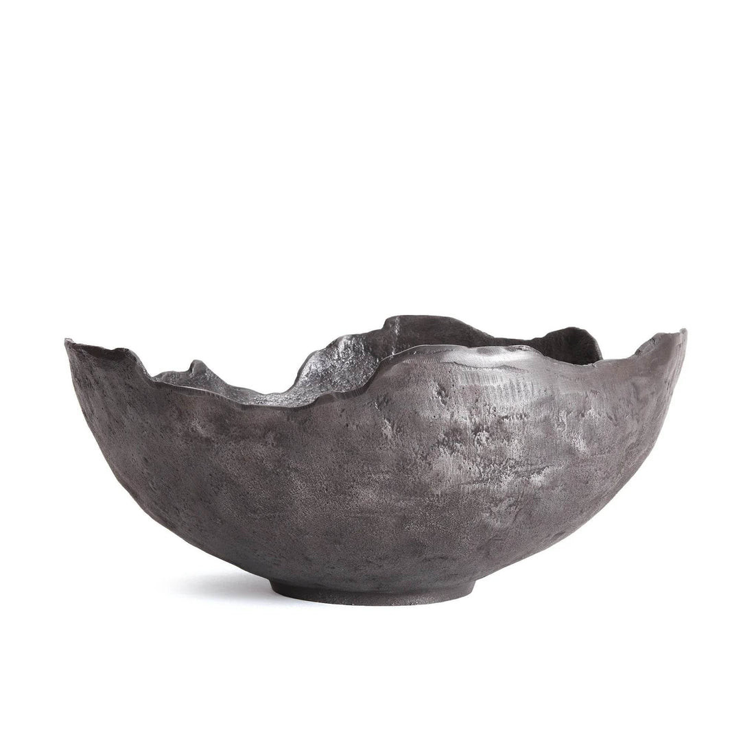 Black decorative bowl with sculptural silhouette, styled on light wood dining table for modern luxe impact