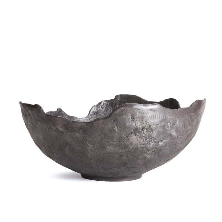 Black decorative bowl with sculptural silhouette, styled on light wood dining table for modern luxe impact