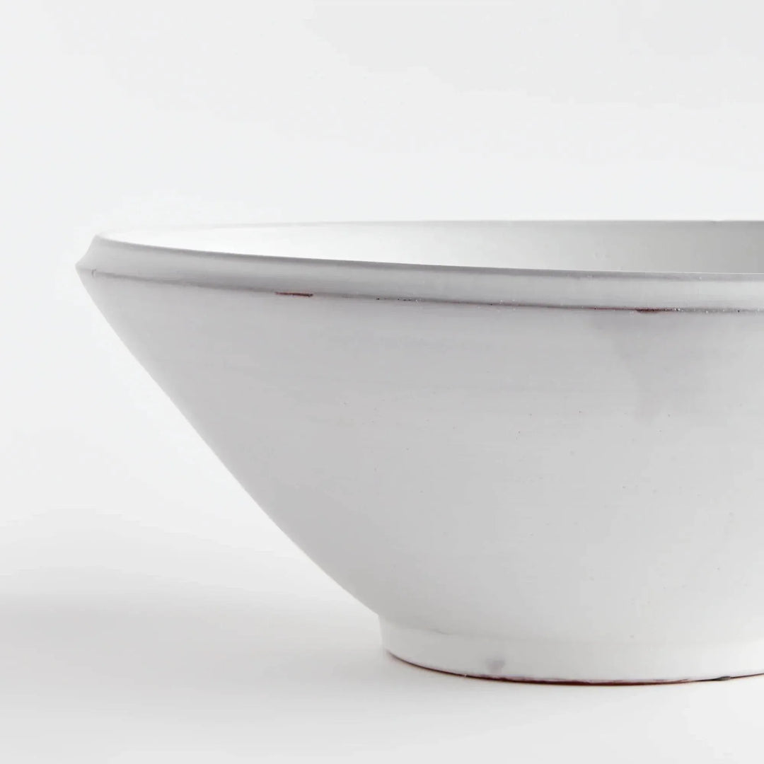 Close view of Aveline warm white terracotta bowl showing its curved rim, horizontal lines and tapered base. Modern Organic
