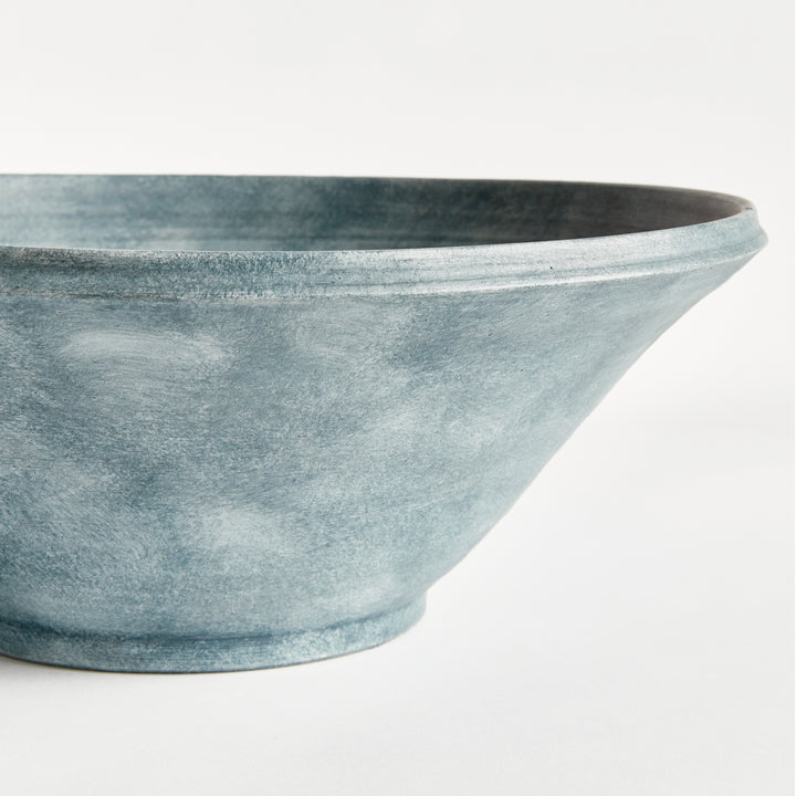 Close view of Aveline washed blue terracotta bowl showing its curved rim, horizontal ribbing and tapered base. Modern Organic