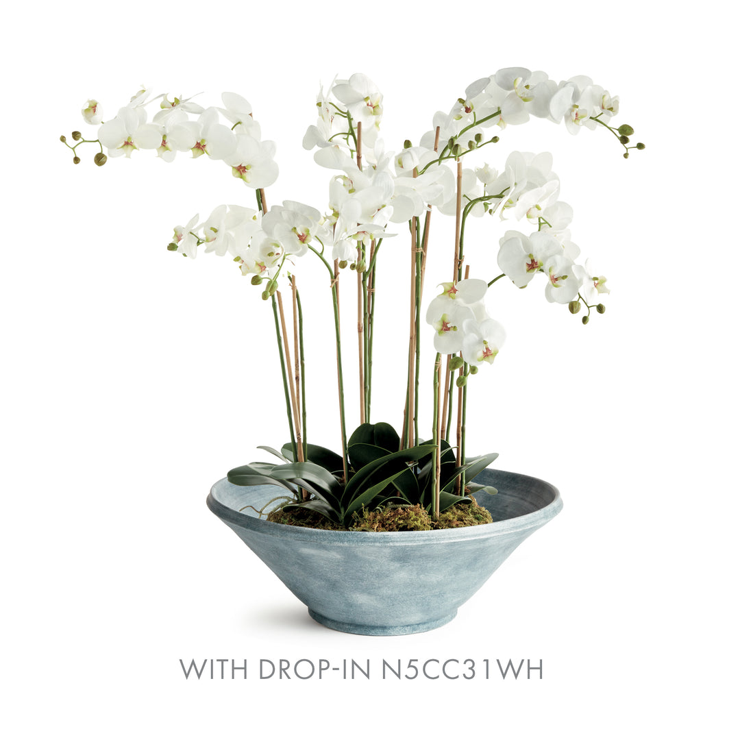 Aveline washed blue terracotta bowl paired with a larger white orchid arrangement, shown on white background. Modern Organic