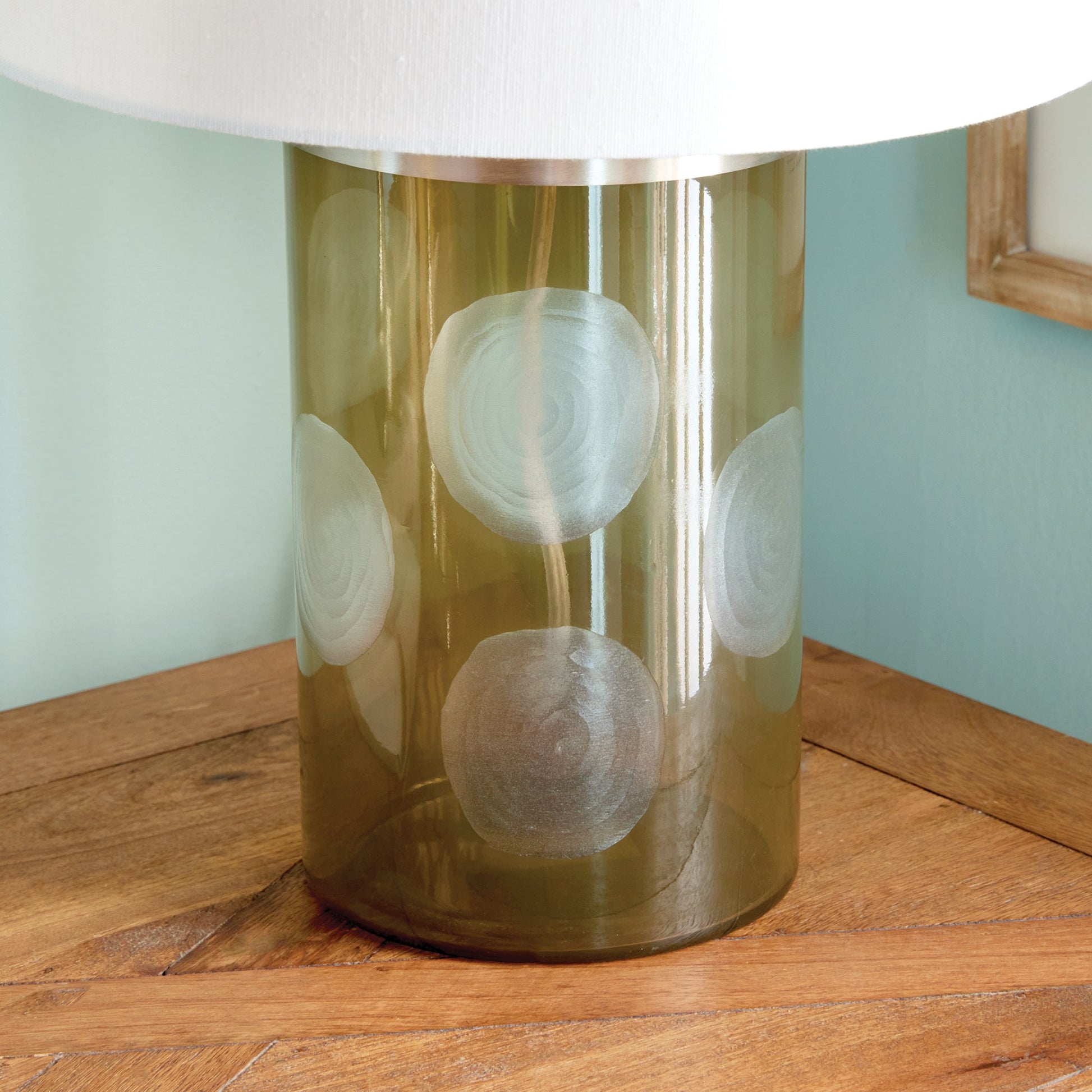 Enhance your home with the Norman Polka Dot Table Lamp, a playful addition that brings a touch of whimsy to any space. Crafted from soft taupe glass and featuring oversized etched polka dots, this lamp is finished with a bright white linen shade, making it a perfect accent for your console, desk, or side table.