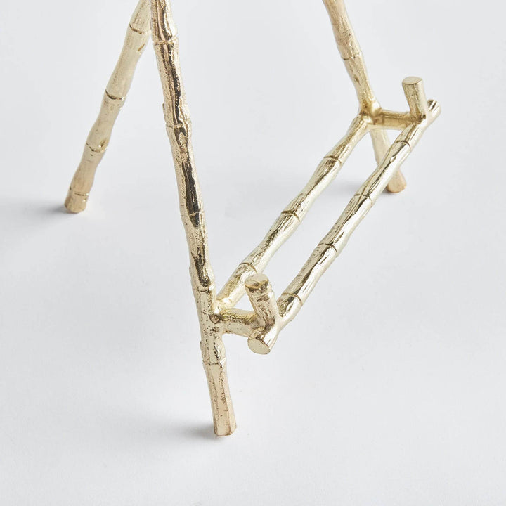 Constructed to hold platters, cookbooks, or a small work of art, this easel is both durable and sturdy. Its elegant gold bamboo accents offer a touch of classic charm, while providing versatility for showcasing your treasured items. With a seamless blend of traditional aesthetics and modern practicality, this easel is a formidable choice.
