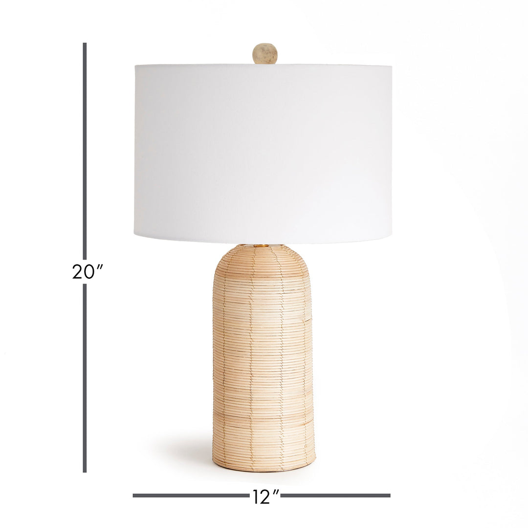 Crafted with a whitewashed cane rattan weave, this table lamp boasts individuality with its varying colors. It's a timeless piece, featuring a wide cylindrical shade that effortlessly complements any room, be it a bedroom, living room, or study.