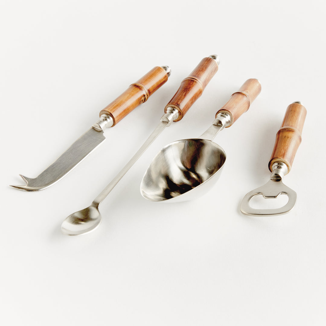 Angled top-down display of 4 stainless steel bar tools with bamboo handles in coastal casual style.